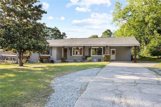 ranch-style house featuring driveway, brick siding, a front lawn, and a carport