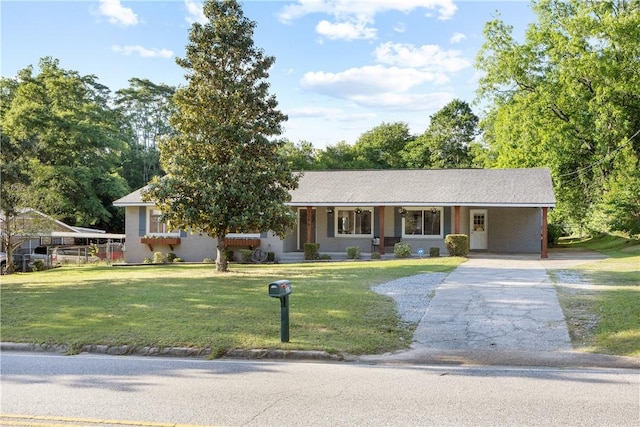 single story home with concrete driveway, a front yard, an attached carport, and a porch