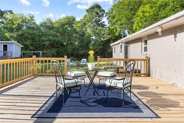 wooden deck featuring view of wooded area