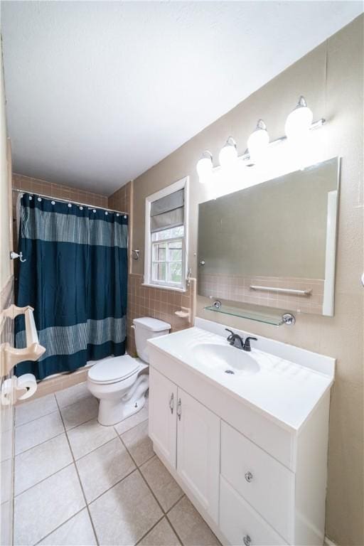 full bath featuring tile walls, toilet, vanity, a shower with curtain, and tile patterned floors