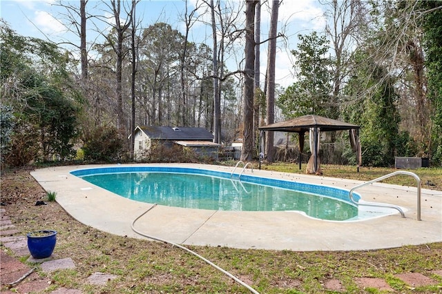 pool featuring an outbuilding, a patio area, and a gazebo