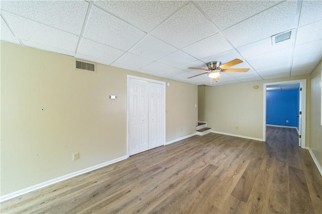 unfurnished room featuring a paneled ceiling, visible vents, and wood finished floors