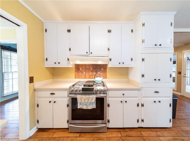 kitchen featuring gas range, under cabinet range hood, white cabinetry, and wood finish floors