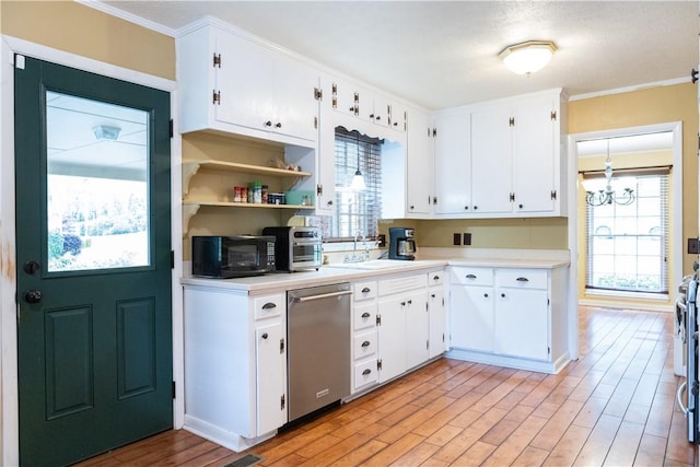 kitchen with black microwave, a sink, light countertops, stainless steel dishwasher, and light wood finished floors