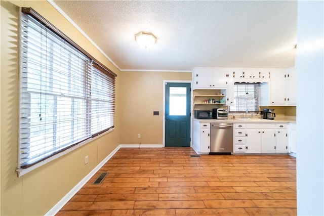 kitchen featuring visible vents, dishwasher, light wood-style flooring, light countertops, and open shelves