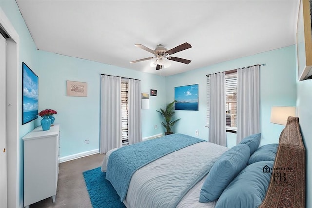 bedroom with ceiling fan, multiple windows, and baseboards