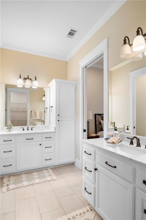 bathroom with ornamental molding, tile patterned flooring, and vanity