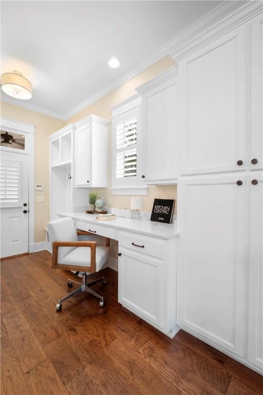 office space with ornamental molding and dark wood-type flooring