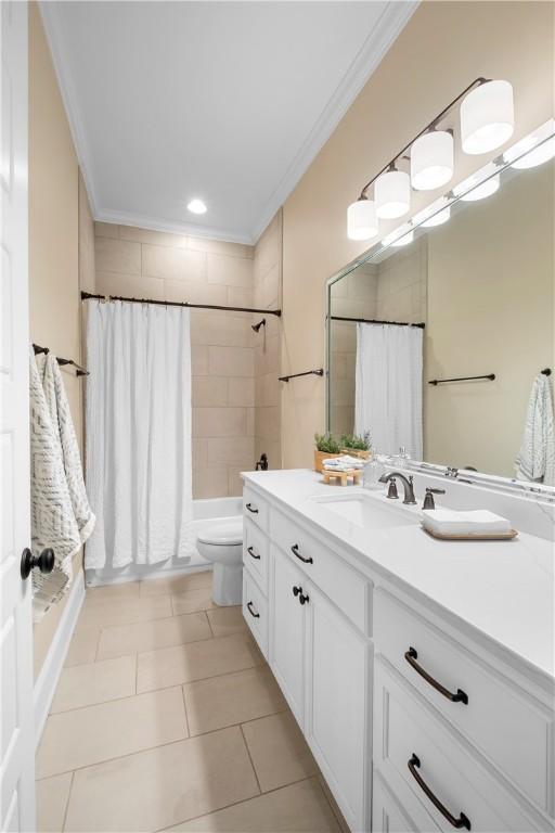 full bathroom with crown molding, toilet, vanity, and shower / bath combo with shower curtain