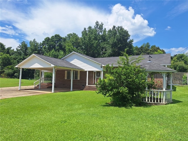 2521 28th Ave, Lanett, AL 36863 - ranch-style house featuring a front lawn, a carport, concrete driveway, a porch, and brick siding
