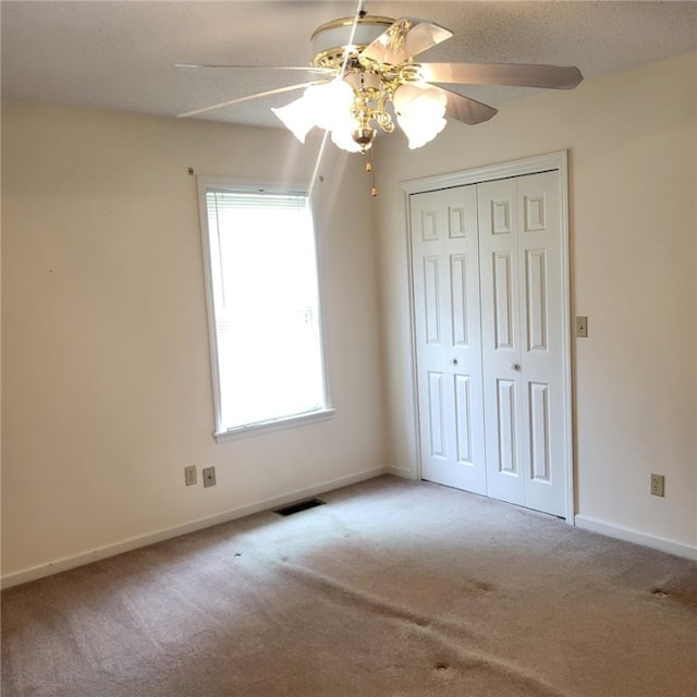 2521 28th Ave, Lanett, AL 36863 - unfurnished bedroom featuring carpet floors, a closet, and a ceiling fan