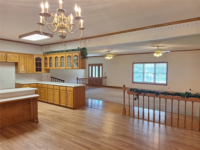 2521 28th Ave, Lanett, AL 36863 - kitchen with healthy amount of natural light, light wood-type flooring, glass insert cabinets, ornamental molding, and a textured ceiling