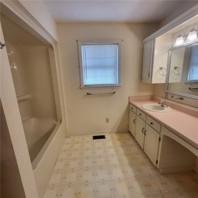 2521 28th Ave, Lanett, AL 36863 - bathroom featuring vanity, tile patterned floors, and a textured ceiling
