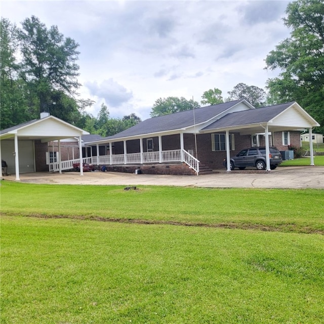 2521 28th Ave, Lanett, AL 36863 - rear view of house featuring a carport, driveway, and a yard
