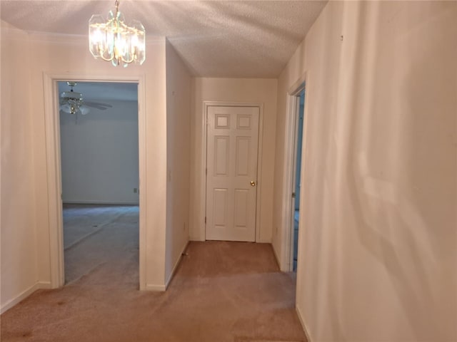 2521 28th Ave, Lanett, AL 36863 - hall featuring carpet, a chandelier, and a textured ceiling