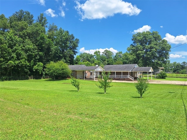 2521 28th Ave, Lanett, AL 36863 - view of front facade with driveway, a detached carport, and a front lawn