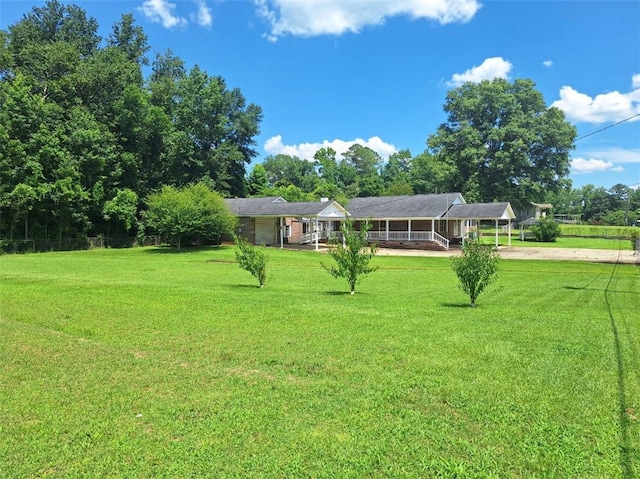 2521 28th Ave, Lanett, AL 36863 - view of grassy yard with a carport, dirt driveway, and a porch