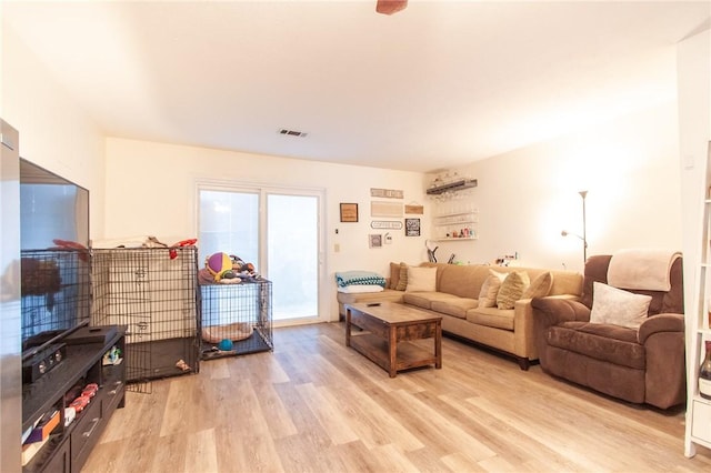 living area with visible vents and light wood-style flooring