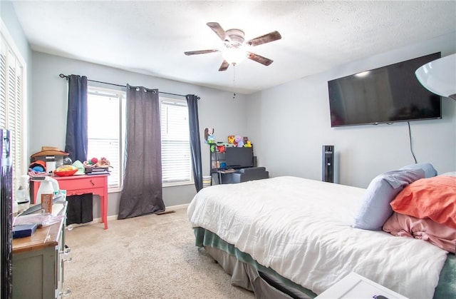 carpeted bedroom featuring baseboards and a ceiling fan