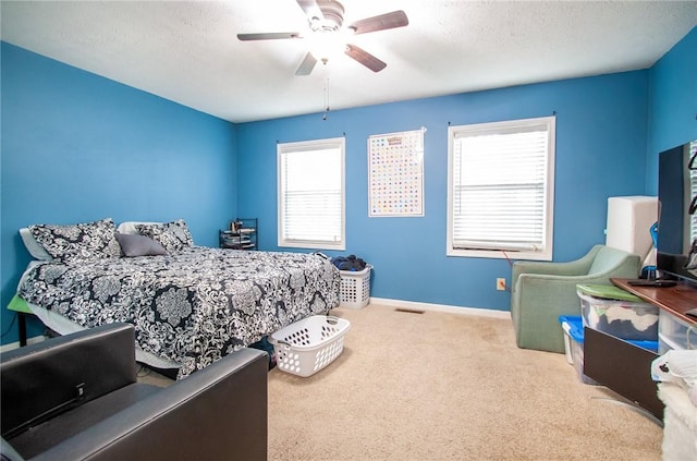 bedroom with carpet, baseboards, multiple windows, and a ceiling fan