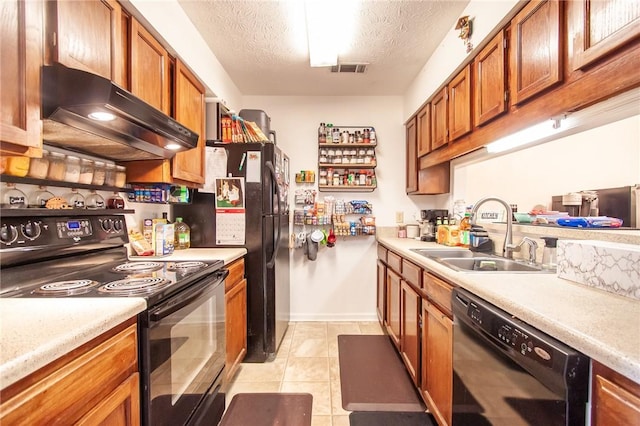 kitchen with a sink, brown cabinetry, exhaust hood, and black appliances