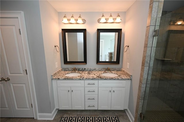 bathroom featuring double vanity, a sink, and a shower stall
