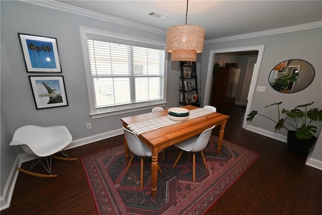 dining space with dark wood finished floors, baseboards, visible vents, and crown molding