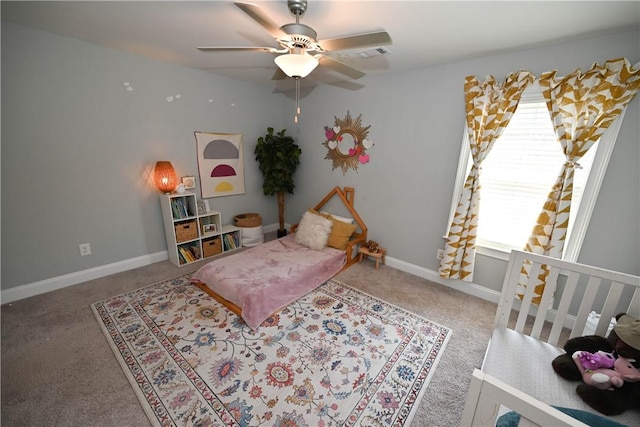 carpeted bedroom featuring baseboards, visible vents, and a ceiling fan