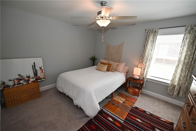 carpeted bedroom with baseboards, ceiling fan, and multiple windows