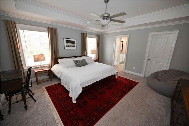 bedroom featuring a tray ceiling, light colored carpet, multiple windows, and ornamental molding