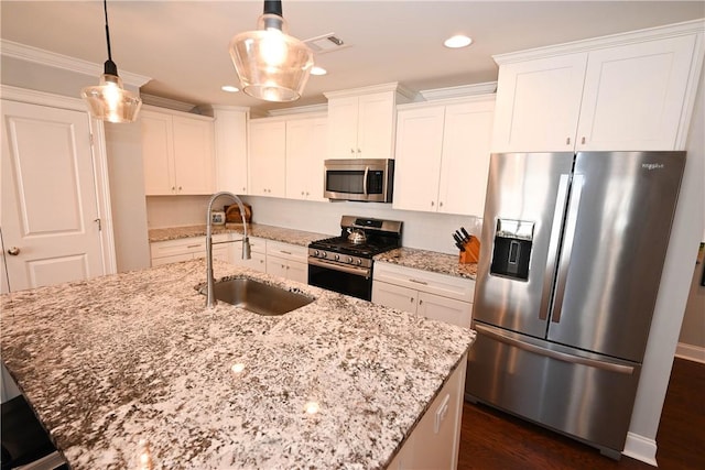 kitchen with a sink, visible vents, appliances with stainless steel finishes, and white cabinetry