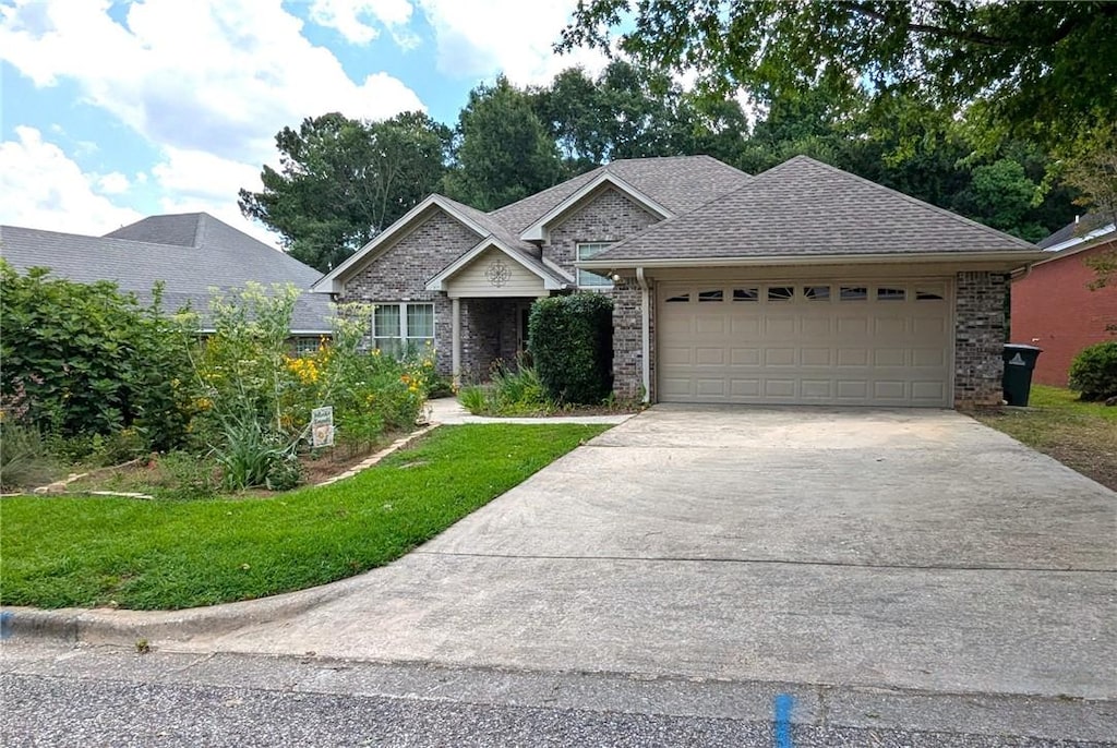 471 Arnell Ln, Auburn, AL 36830 - view of front facade featuring driveway, an attached garage, a front yard, and brick siding