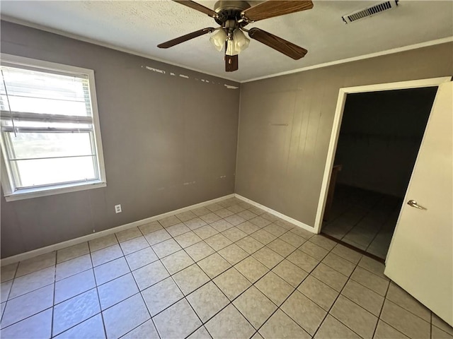 unfurnished room with light tile patterned floors, baseboards, and a ceiling fan