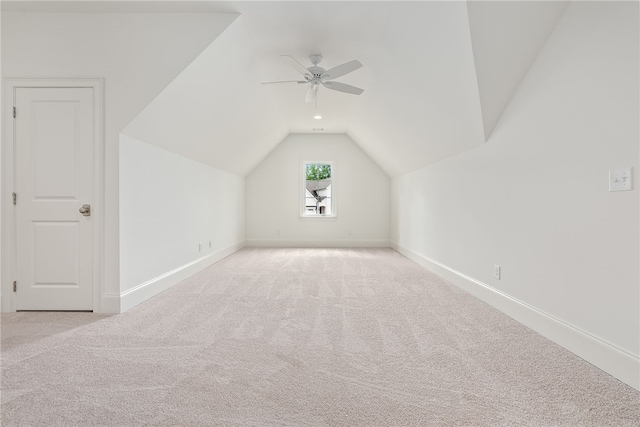 additional living space with ceiling fan, lofted ceiling, and light carpet