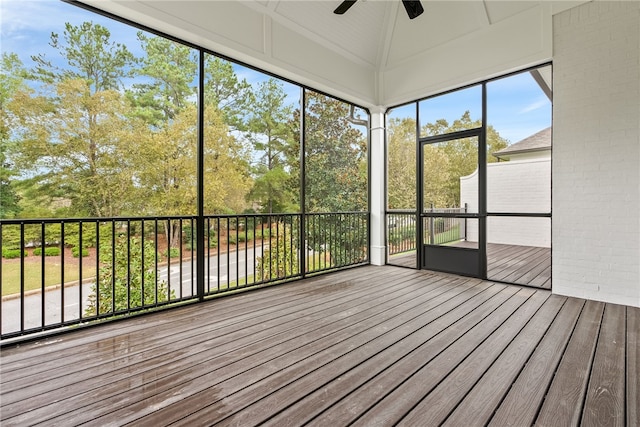 unfurnished sunroom with ceiling fan