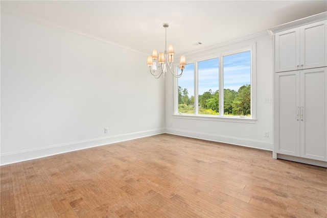 interior space with ornamental molding, light hardwood / wood-style flooring, and a notable chandelier