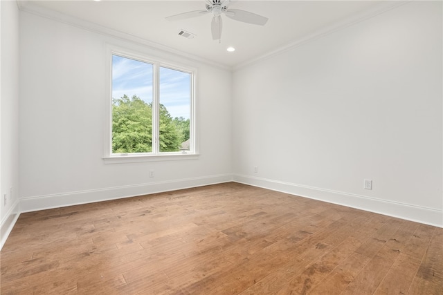 empty room with ceiling fan, wood-type flooring, and ornamental molding