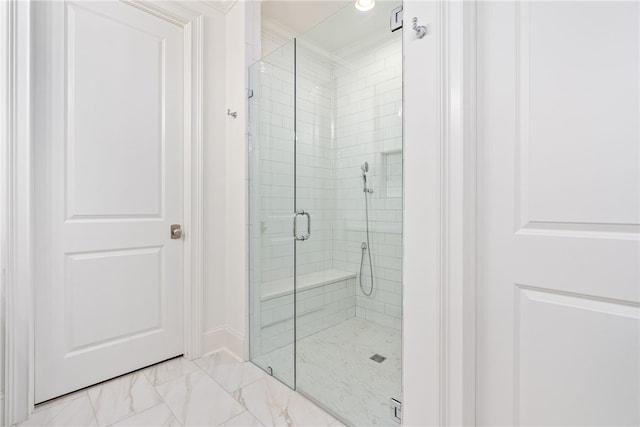 bathroom featuring an enclosed shower and crown molding