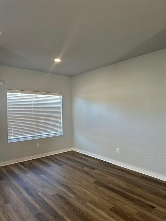 spare room featuring dark hardwood / wood-style floors