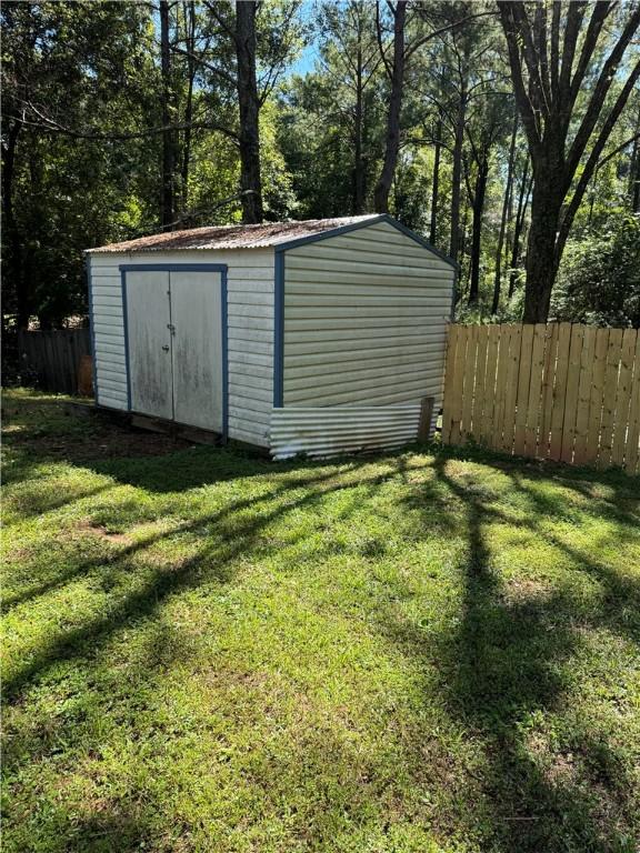 view of outbuilding with a lawn