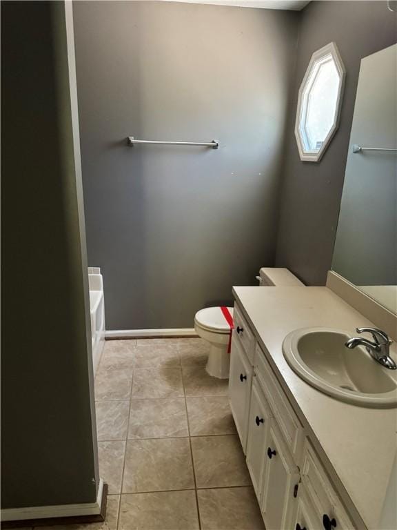 bathroom with tile patterned flooring, vanity, toilet, and a bathing tub