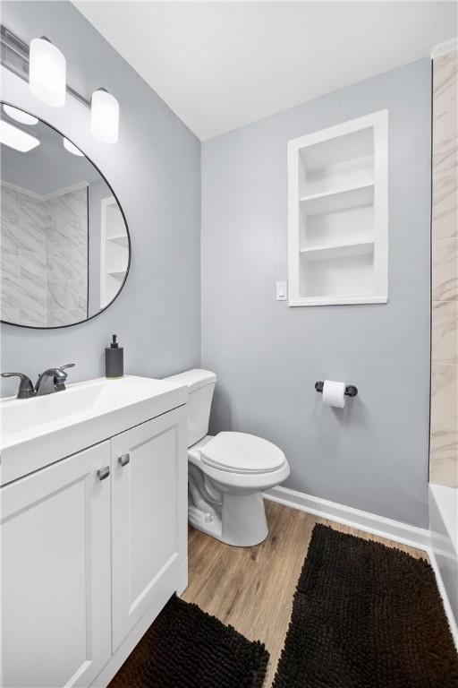 511 Lankford St, Opelika, AL 36801 - full bath featuring toilet, wood finished floors, built in features, and vanity