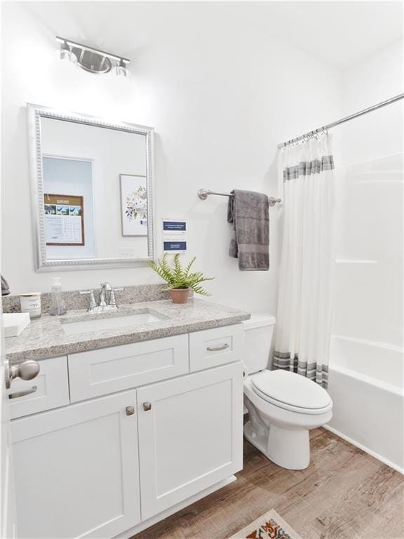 0103 Bradley Ln, Auburn, AL 36830 - bathroom featuring wood finished floors, vanity, toilet, and shower / bath combo with shower curtain