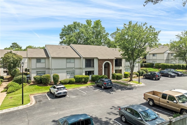 601 N Gay St Unit 202, Auburn, AL 36830 - view of property featuring uncovered parking and a residential view