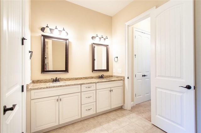 bathroom with tile patterned floors and vanity