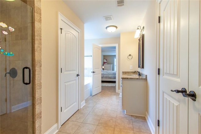 bathroom featuring tile patterned flooring, vanity, and an enclosed shower