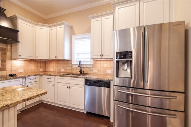 kitchen with white cabinets, sink, tasteful backsplash, light stone counters, and stainless steel appliances