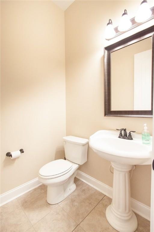 bathroom with tile patterned flooring and toilet