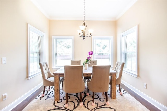 dining room with a healthy amount of sunlight, ornamental molding, dark wood-type flooring, and a chandelier