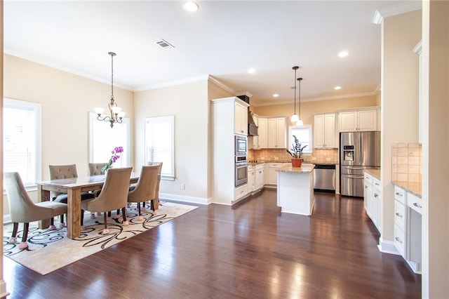 dining space featuring dark hardwood / wood-style floors, crown molding, and a notable chandelier